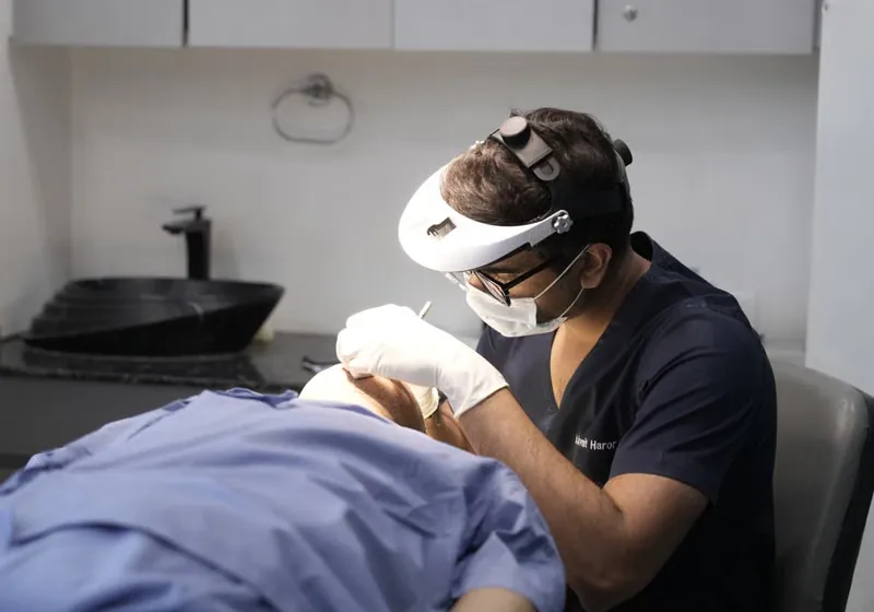Dentist performing adult bite correction and alignment orthodontic procedure at Deekshu Dental Sarjapura